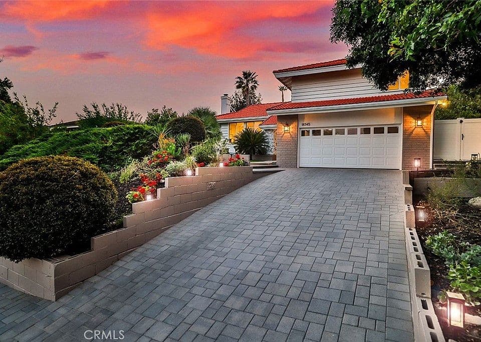 CCTV view of a residential driveway and front entrance at dusk