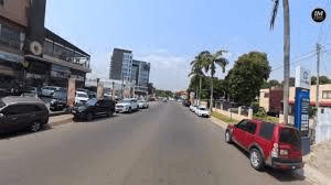 CCTV view of a street with parked cars along commercial buildings