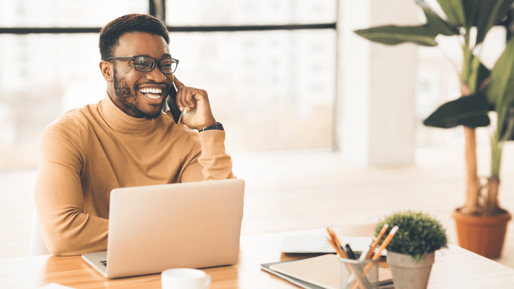 Professional on a client call while working at a modern desk